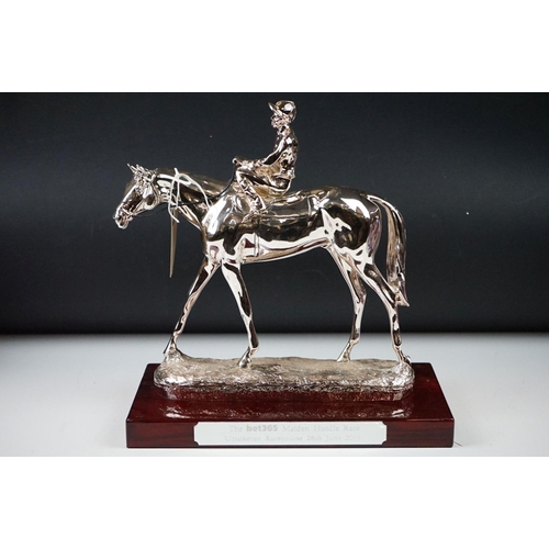 326 - Two horse racing trophies together with a brass door stop in the form of a horse and a pair of horse... 