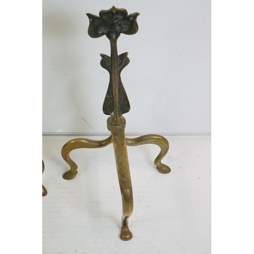 333 - A pair of Art Nouveau brass fire dogs the stylised floral decoration together with brass companion s... 