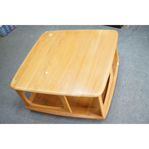 454 - Ercol Pale Elm ' Pandora's Box ' Square Coffee Table with under-shelf and two drawers, raised on cas... 