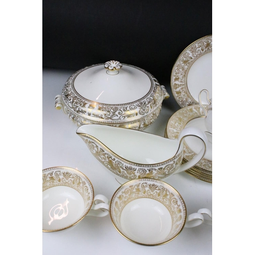 117 - Wedgwood 'Gold Florentine' part dinner service for 6 (pattern no. W4219), to include 2 tureens & cov... 