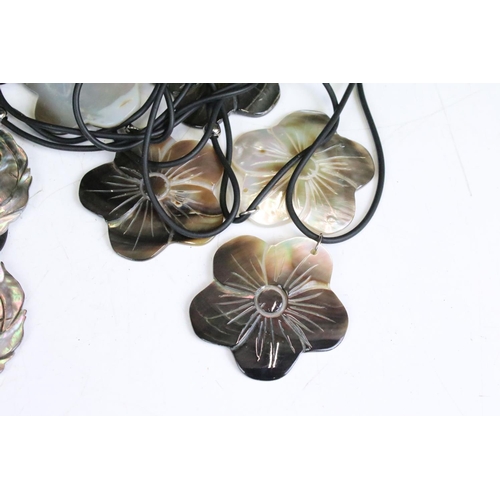 310 - Collection of mother of pearl daisy pendants on leather strings and Collection of Mother of Pearl Lo... 