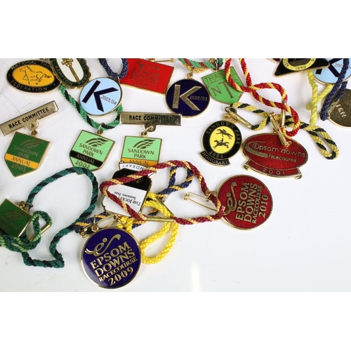 311 - A collection of horse racing collectables to include a good quantity of racecourse badges and a coll... 