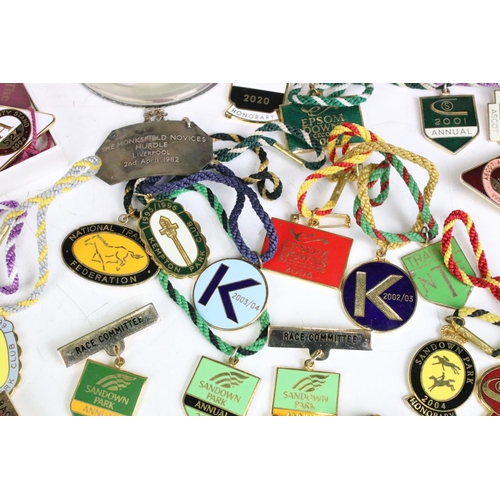 311 - A collection of horse racing collectables to include a good quantity of racecourse badges and a coll... 