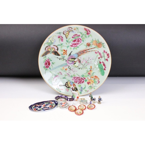 15 - 19th Century Chinese famille rose plate being hand decorated with birds of paradise to the centre su... 