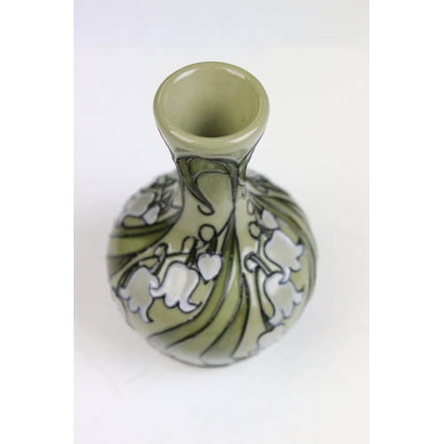 20 - Moorcroft - A Hibiscus pattern tube lined plate together with a small tube lined vase decorated with... 