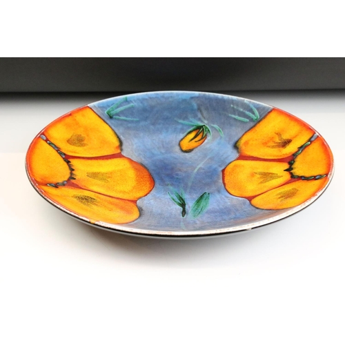 25 - Poole Pottery Wild Poppy - A large centrepiece / wall plate having a blue ground with orange florals... 