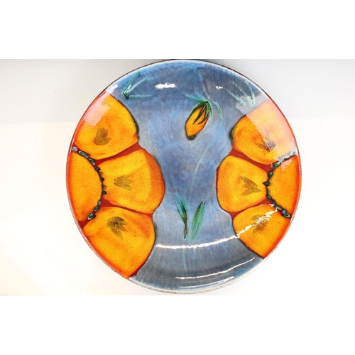 25 - Poole Pottery Wild Poppy - A large centrepiece / wall plate having a blue ground with orange florals... 