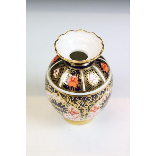 4 - Two pieces of Royal Crown Derby ceramics to include an oval dish and a small vase. Both decorated in... 