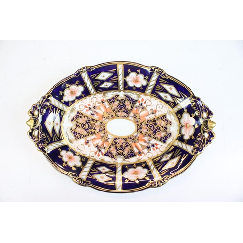 4 - Two pieces of Royal Crown Derby ceramics to include an oval dish and a small vase. Both decorated in... 