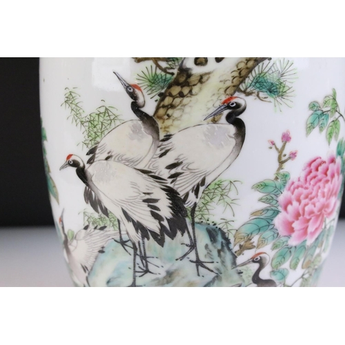 19 - 20th Century Chinese vase featuring peonies and cranes perched on a pine tree with blue painted bord... 