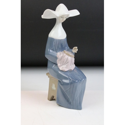 35 - Group of three Lladro figurines in the form of nuns, to include one group figurine and two individua... 