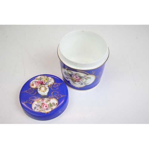 57 - Two porcelian dressing table pots, each having a blue ground with hand painted floral panels. Unmark... 