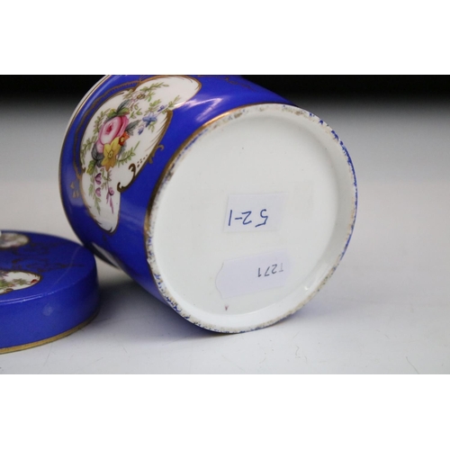 57 - Two porcelian dressing table pots, each having a blue ground with hand painted floral panels. Unmark... 