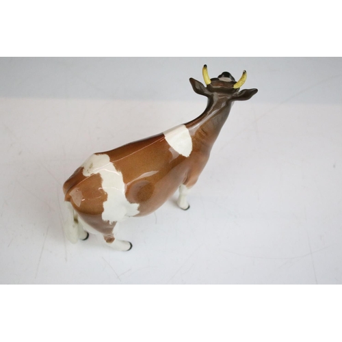 64 - Group of Beswick ceramic animal figurines. The lot to include a pig, ram, two sheep and two cows. Co... 