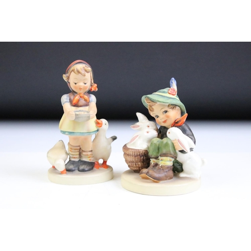 66 - Fourteen Hummel Goebel figurines to include a postman, boy with lamb, flute player etc. Tallest meas... 