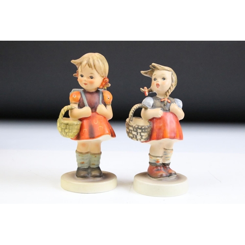 66 - Fourteen Hummel Goebel figurines to include a postman, boy with lamb, flute player etc. Tallest meas... 