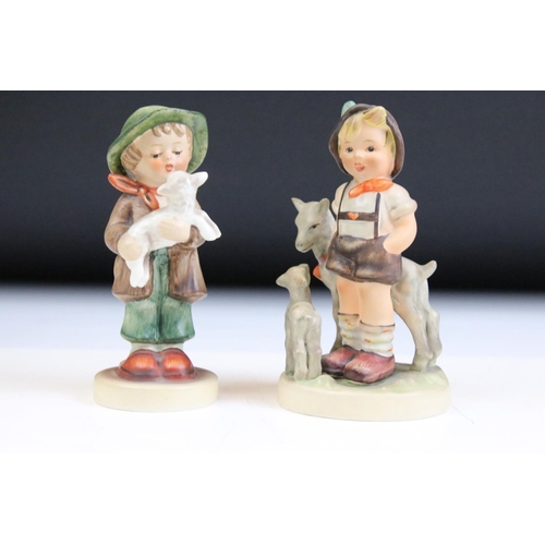 66 - Fourteen Hummel Goebel figurines to include a postman, boy with lamb, flute player etc. Tallest meas... 