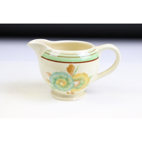 69 - Clarice Cliff for Newport Pottery - an Art Deco matching cream jug and sugar bowl having hand painte... 