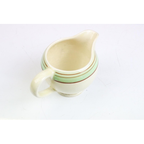 69 - Clarice Cliff for Newport Pottery - an Art Deco matching cream jug and sugar bowl having hand painte... 