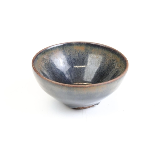 76 - Set of four Chinese blue and brown drip glaze bowls. Measures 9cm diameter.