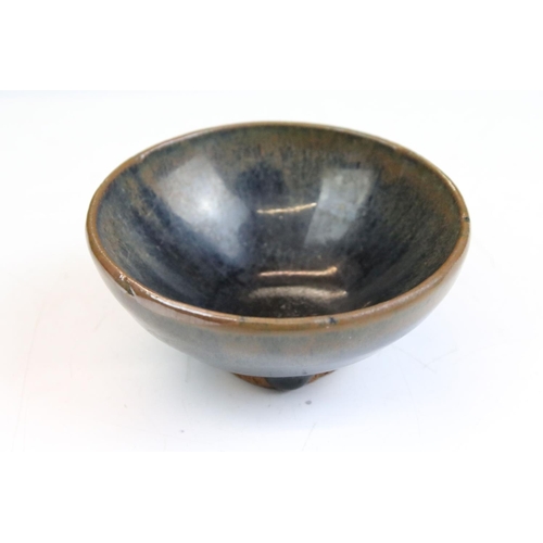 76 - Set of four Chinese blue and brown drip glaze bowls. Measures 9cm diameter.