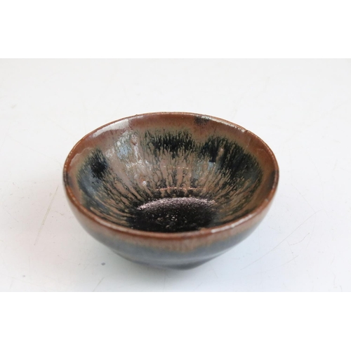 76 - Set of four Chinese blue and brown drip glaze bowls. Measures 9cm diameter.