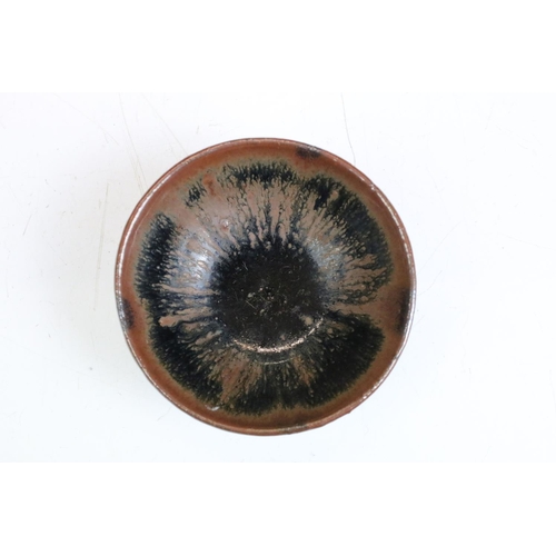 76 - Set of four Chinese blue and brown drip glaze bowls. Measures 9cm diameter.