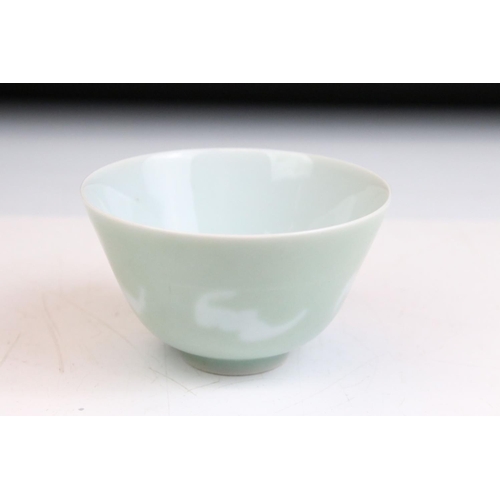 79 - Chinese celadon glazed tea bowl with bat motifs to the sides and six character reign mark to the bas... 