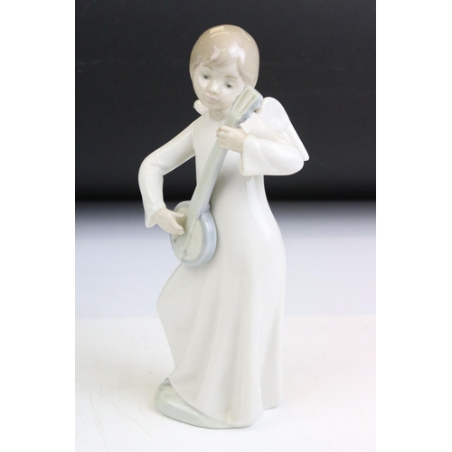 85 - Group of nine Nao figurines and two Lladro figurines. The Lladro to include a girl with hands on her... 