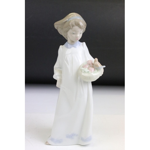 85 - Group of nine Nao figurines and two Lladro figurines. The Lladro to include a girl with hands on her... 