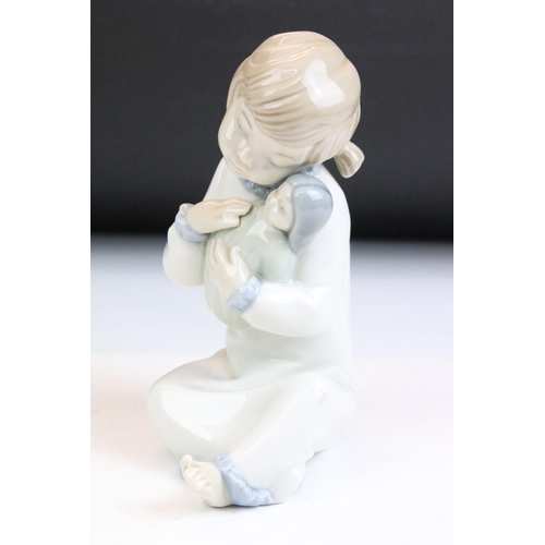 85 - Group of nine Nao figurines and two Lladro figurines. The Lladro to include a girl with hands on her... 