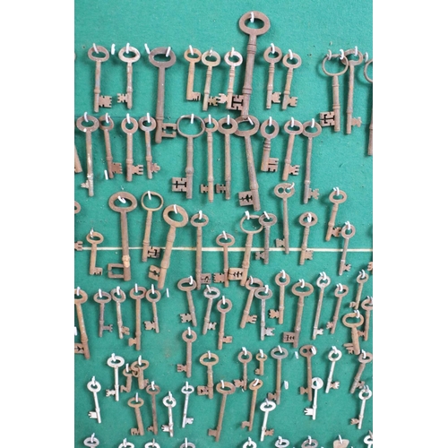 113 - Large collection of old keys contained within a glazed key cabinet.