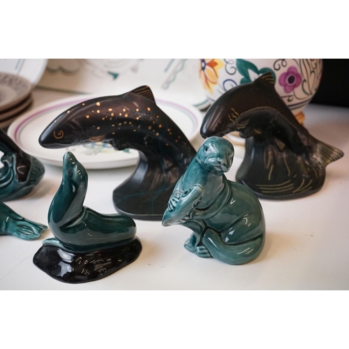 111 - Collection of Poole pottery to include two trout, three dolphins, otter, seal, manitee, matching fis... 