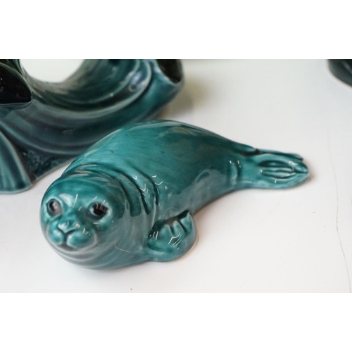 111 - Collection of Poole pottery to include two trout, three dolphins, otter, seal, manitee, matching fis... 