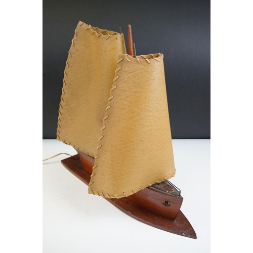 119 - Art Deco table lamp in the form of a boat of wooden construction with two hide sails. Measures 41cm ... 