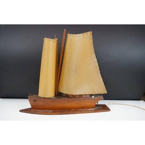 119 - Art Deco table lamp in the form of a boat of wooden construction with two hide sails. Measures 41cm ... 