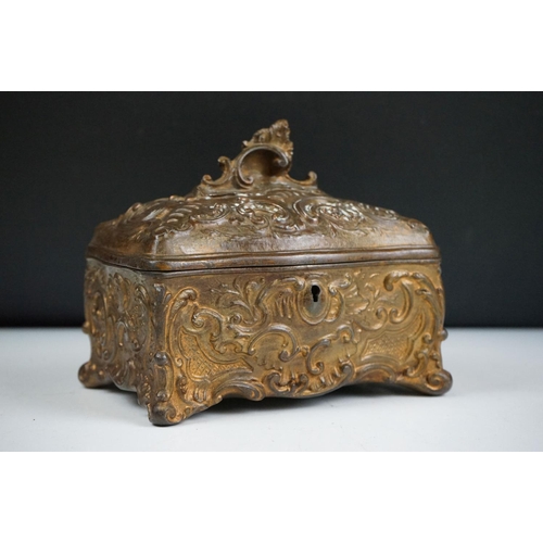 145 - 19th century Metal Jewellery Casket in the Rococo manner with foliate scroll casting, the hinged lid... 