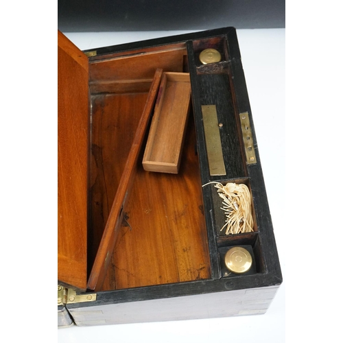 165 - 19th Century mahogany writing slope having brass banding to the exterior opening to reveal a black t... 