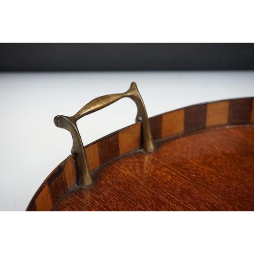 169 - Early 20th Century mahogany inlaid kidney shaped tray having marquetry galleried sides and twin bras... 