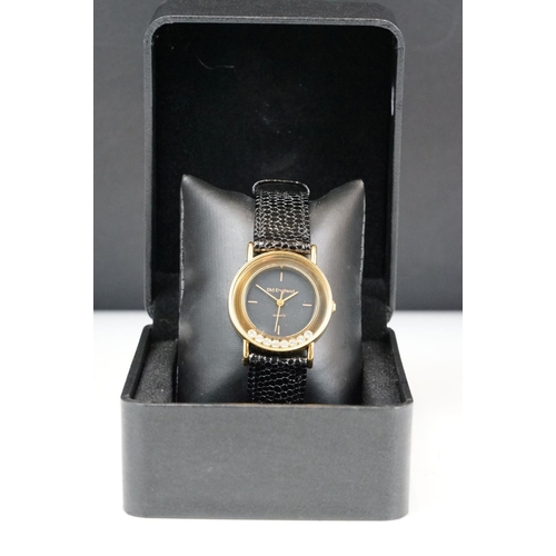 218 - A contemporary Old England quartz wristwatch with black dial, complete with display case.