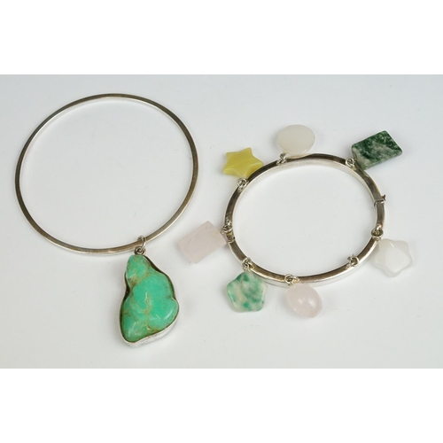 219 - Two white metal ladies bangles with decorative stone charms. Made and Designed by Guy Morey from the... 