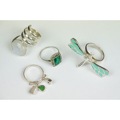 222 - A collection of four 925 sterling silver rings to include a Dragonfly example with articulated wings... 