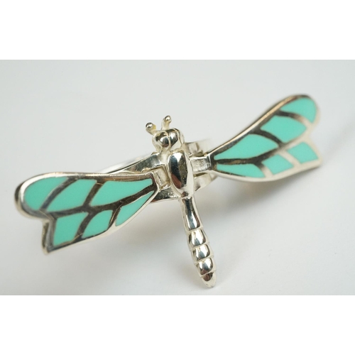 222 - A collection of four 925 sterling silver rings to include a Dragonfly example with articulated wings... 