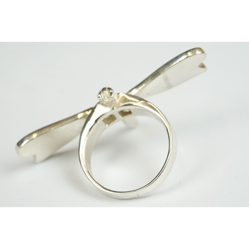 222 - A collection of four 925 sterling silver rings to include a Dragonfly example with articulated wings... 