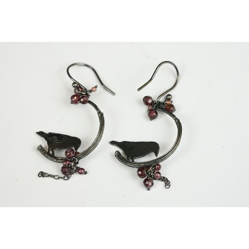 223 - A pair of white metal ladies drop earrings with bird decoration.