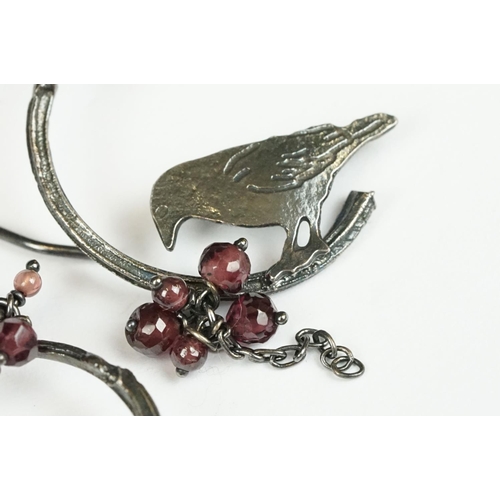 223 - A pair of white metal ladies drop earrings with bird decoration.