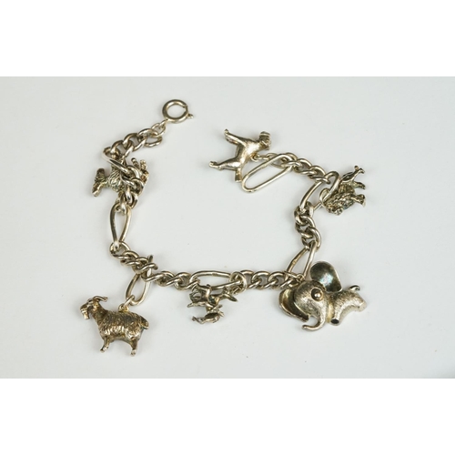 229 - A sterling silver charm bracelet together with six charms in the form of different animals.