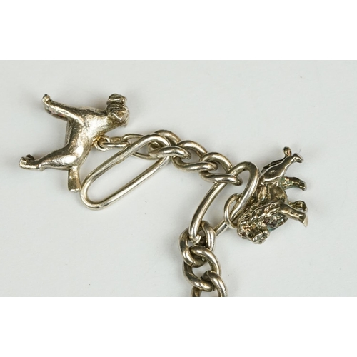 229 - A sterling silver charm bracelet together with six charms in the form of different animals.