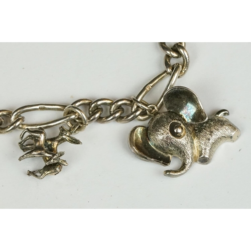 229 - A sterling silver charm bracelet together with six charms in the form of different animals.