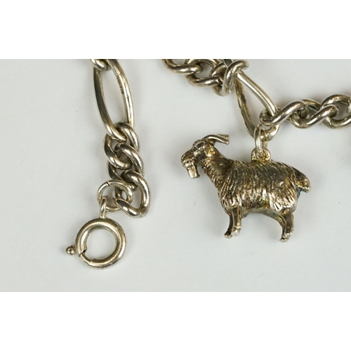 229 - A sterling silver charm bracelet together with six charms in the form of different animals.